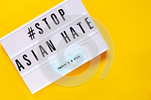 Stop Asian hate concept, text on light board on yellow background