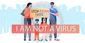 stop asian hate family in masks holding banner against racism support people during coronavirus pandemic