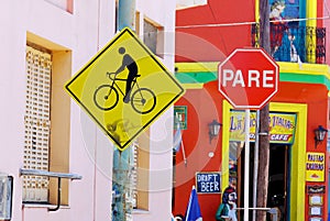 Stop and bike sign in colorful area in La Boca neighborhood.
