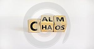 Stop chaos, time to calm. The words `chaos` and `calm` on wooden cubes. Beautiful white background, copy space. Business and c
