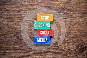 Stop checking social media - word concept on building blocks, text