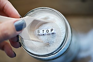 Stop consuming excessive salt with wooden spoon on salt-cellar