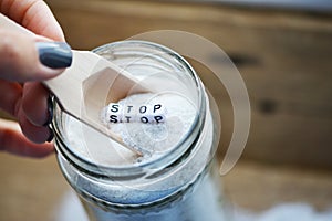 Stop consuming excessive salt with wooden spoon on salt-cellar