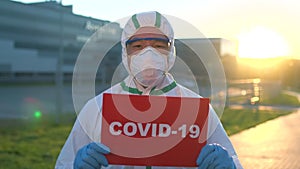 Stop Coronavirus Covid-19 epidemic outbreak. Asian Chinese Korean man doctor virologist scientist in face mask PPE