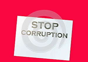 Stop Corruption Words on page and paper dollar signs around on wooden table. Anticorruption business concept photo