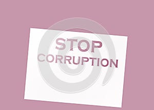 Stop Corruption Words on page and paper dollar signs around on wooden table. Anticorruption business concept