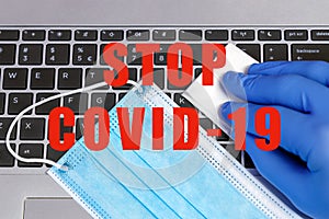 Stop COVID-19 Coronavirus Prevention Concept Disinfection of Workspace Person Cleaning Laptop Keybord with Disinfecting Wipes