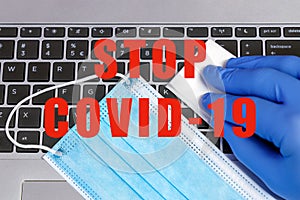 Stop COVID-19 Coronavirus Prevention Concept Disinfection of Workspace Person Cleaning Laptop Keybord with Disinfecting Wipes photo