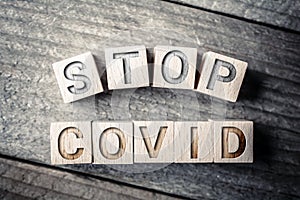 Stop Covid Written On Wooden Blocks On A Board photo