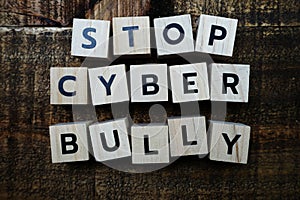 Stop cyber Bully alphabet letters on wooden background