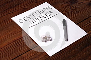 Stop Diabetes sign on a white paper sheet with sugar cubes on wooden background,prevention disease,detection diagnosis photo