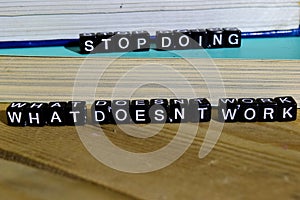 Stop doing what doesn`t work on wooden blocks. Motivation and inspiration concept.