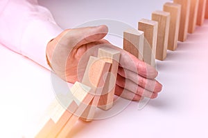 Stop Domino Effect - Hand Prevents Failure photo
