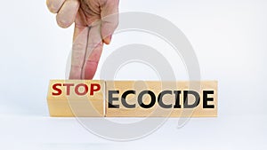 Stop ecocide symbol. Businessman turns a cube and changes words ecocide to stop ecocide. Beautiful white background, copy space.