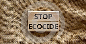 Stop ecocide symbol. Wooden blocks with words stop ecocide. Beautiful canvas background, copy space. Business, ecological and stop