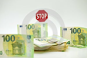Stop euro currency.euro money inflation. Refusal to pay in euros.Euro banknotes and stop sign on white background. The