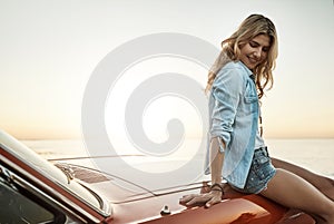 Stop at every moment that makes you happy. a young woman enjoying a road trip along the coast.
