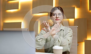 Stop gesture, businesswoman disagree, denial. Woman in office workplace says no