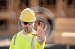 Stop gesture. Portrait worker in construction helmet. Engineer builder foreman or repairman. Worker at building site
