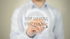 Stop Guessing Start Knowing, man writing on transparent screen
