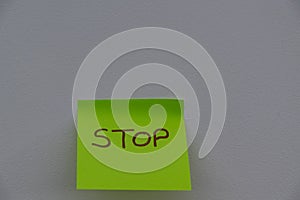 Stop hand wrote on a sticky note, isolated. Danger, safeguard, half, protection concept background. Copy space, Simple concepts