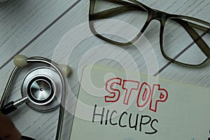 Stop HICCUPS write on a book isolated on office desk. Healthcare or Medical concept