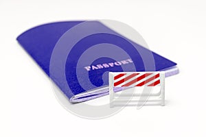 Stop illegal migration concept, blue passport with a road barrier on white background