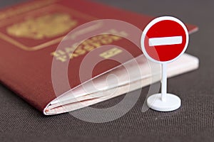 Stop illegal migration concept, Russian passport and stop sign close up.