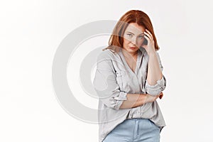 Stop it. Irritated displeased annoyed redhead middle-aged pressured woman touch temple look from under forehead scorn