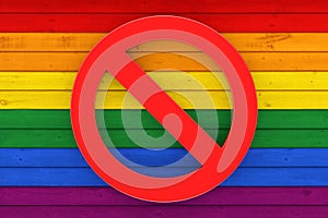 Stop LGBT Concept. Prohibit Symbol over Rustic Old Weathered Wood Plank Background Texture in colours of LGBT Pride Flag. 3d