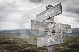 Stop the lies text quote on signpost outdoors