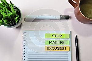 Stop Making Excuses! text on sticky notes with office desk concept