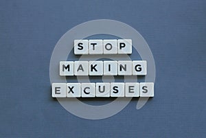 ' Stop Making Excuses ' word made of square letter word on grey background