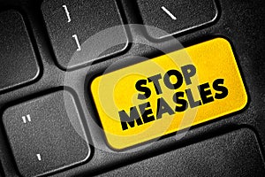 Stop Measles - get the measles, mumps, and rubella (MMR) vaccine, text button on keyboard, concept background