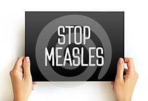 Stop Measles - get the measles, mumps, and rubella MMR vaccine, text concept on card