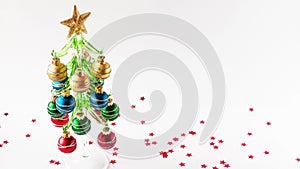 Stop motion animation of Christmas concept. One by one red, green, blue and cold balls decorate the decorative xmas tree with star