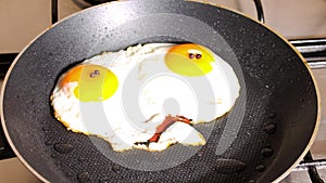 Stop motion animation of a funny scrambled egg talking and moving its mouth. Early breakfast, fried eggs in a pan