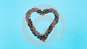 Stop motion animation photography. Pumpkin seeds in shape of heart on blue background, disappears and appears.