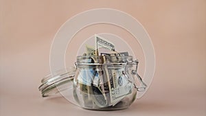 Stop motion of Dollar banknote money spend from glass jar. Consumption and economy Collecting money. Tips. Business