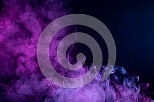 Stop the movement of multicolored smoke on dark background