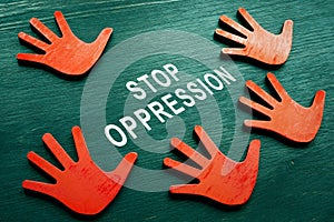 Stop oppression concept. Red hands and phrase. photo