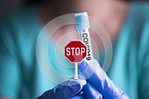 Stop pandemic Coronavirus or Covid19 illness concept with medic holding medical virus container