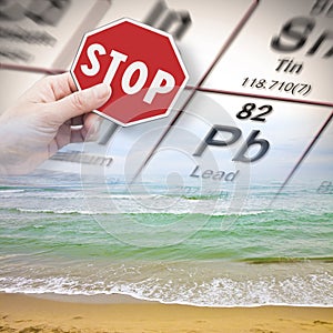 Stop pollution from dangerous lead and heavy metals in seawater - concept with hand holding a stop sign against a lead chemical