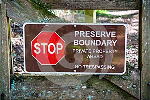 `Stop; Preserve Boundary; Private Boundary Ahead; No trespassing` sign