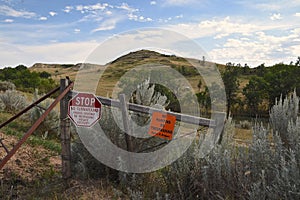 Stop and Private Property signs with rangeland in th4 Badlands of North Dakota