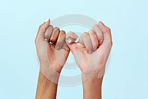 Stop racism. African and Caucasian hands gesturing on a blue studio background. Tolerance and equality, unity concept