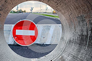 A stop road sign and concrete blocks block the entrance to the construction site. Closed road. Construction and road works