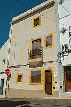 STOP road sign in front colorful house with terrace