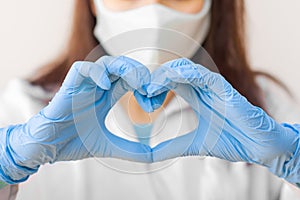 Stop SARS-CoV, SARSCoV, virus 2020 , MERS-CoV ,chinese virus COVID-19. Closeup womens hand in blue medical gloves show heart sign