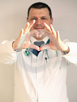COVID-19. Male doctor`s hands show a heart sign. HIV protection concept. Doctor shows a heart symbol. Healthcare